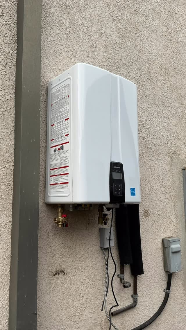 Tankless water heater installed on an exterior wall